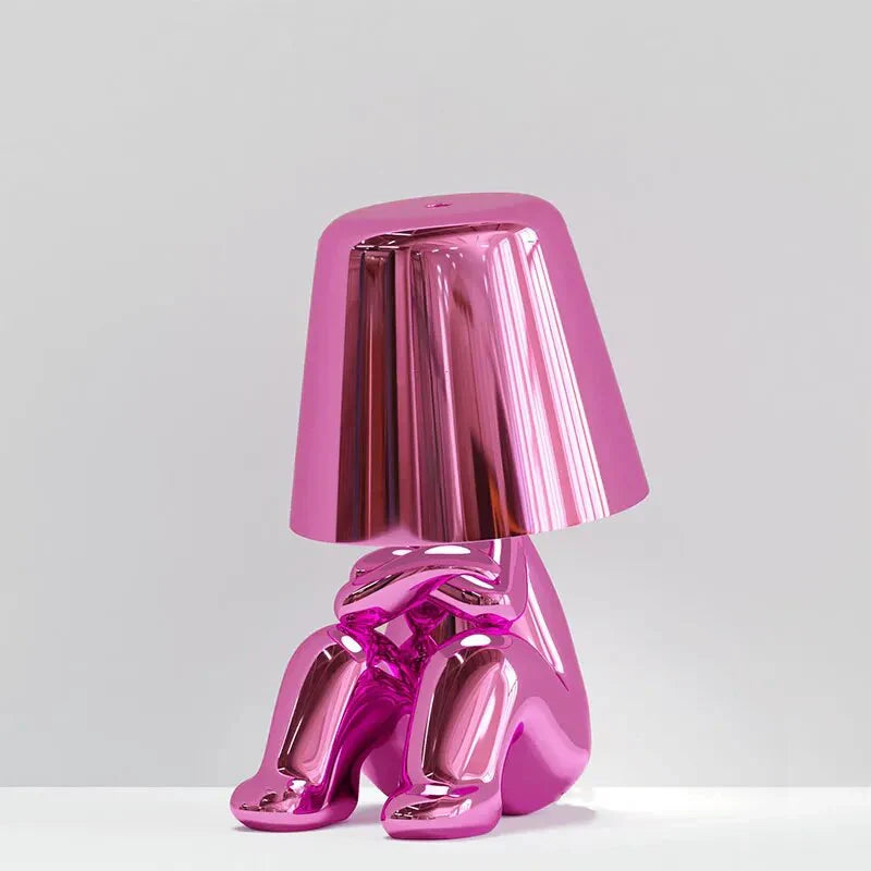 Modern metallic figurine table lamp featuring a 'Thinker' sculpture design, emits a warm LED glow, perfect for elegant decor.