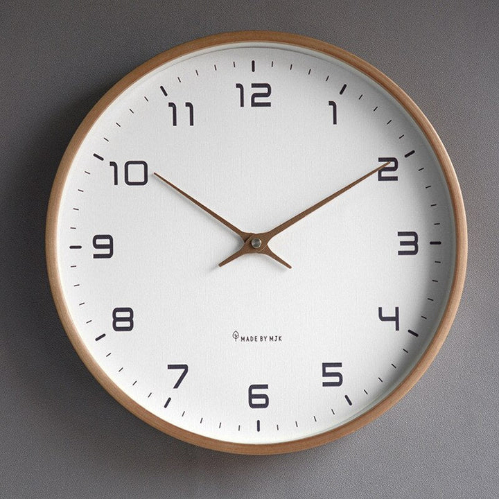 Scandinavian minimalist wooden wall clock with a simple circular design, cream and brown colors, fits modern home interiors.