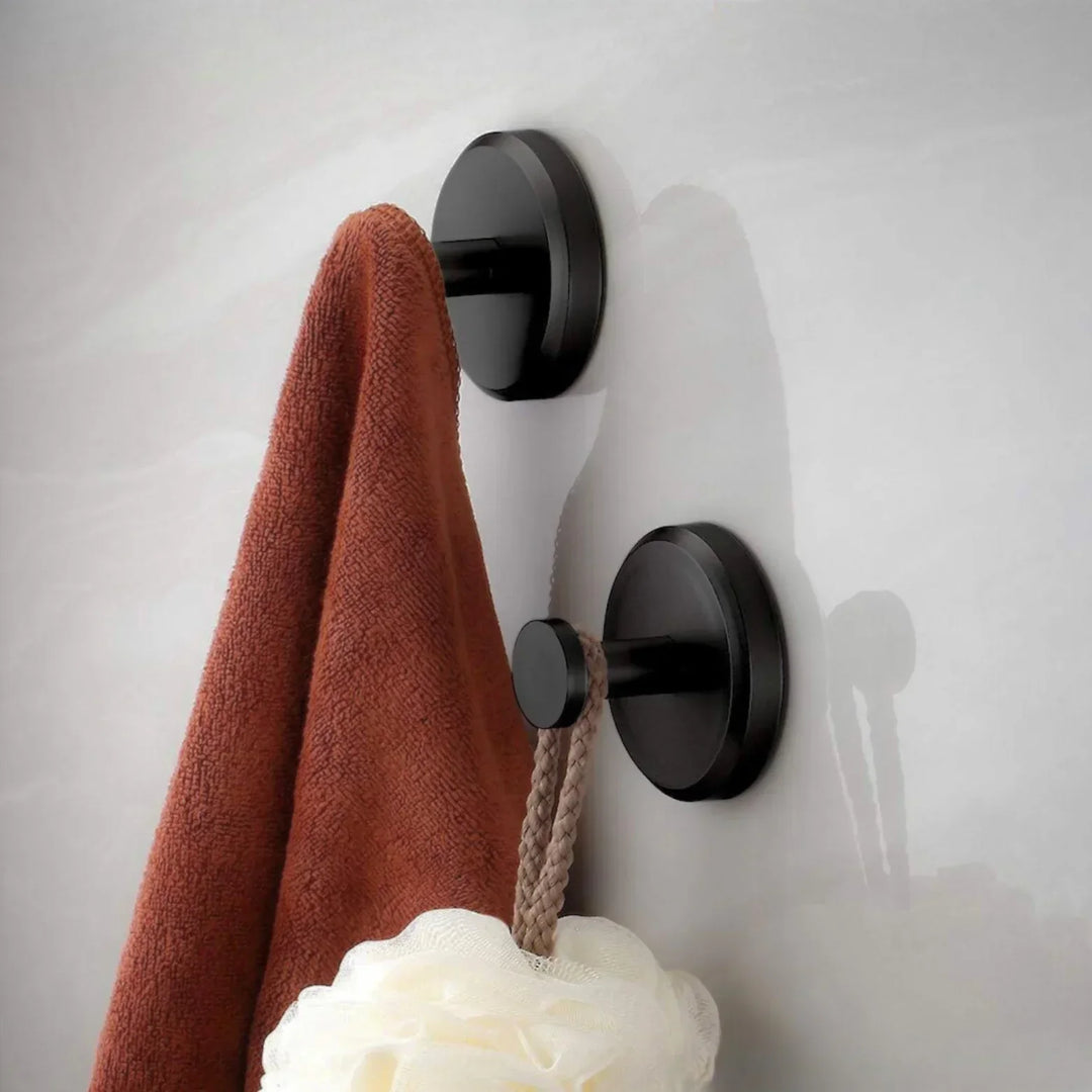 "Set of 4 sleek suction wall hooks for organized storage, perfect for bathrooms or kitchens. Supports up to 7 kg each."