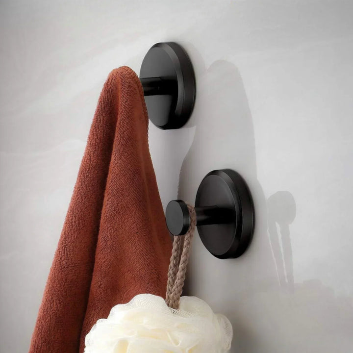 "Set of 4 sleek suction wall hooks for organized storage, perfect for bathrooms or kitchens. Supports up to 7 kg each."