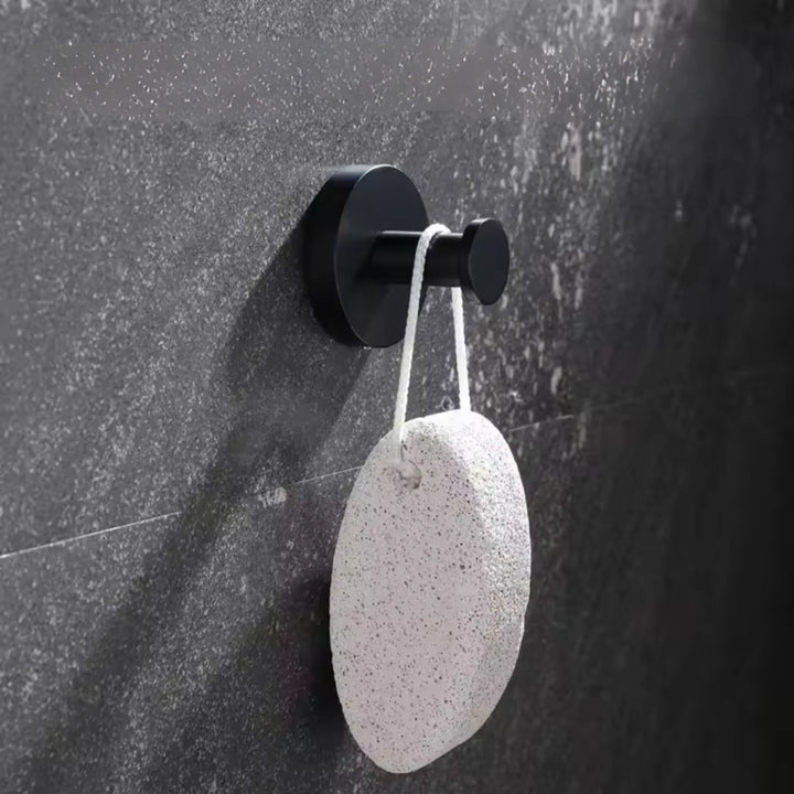 "Set of 4 sleek suction wall hooks for organized storage, perfect for bathrooms or kitchens. Supports up to 7 kg each."