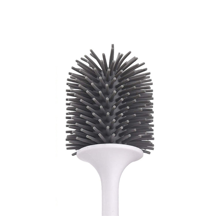 "Silicone toilet brush with non-scratch bristles, white wall-mounted design, keeps bathrooms pristine and surfaces undamaged.