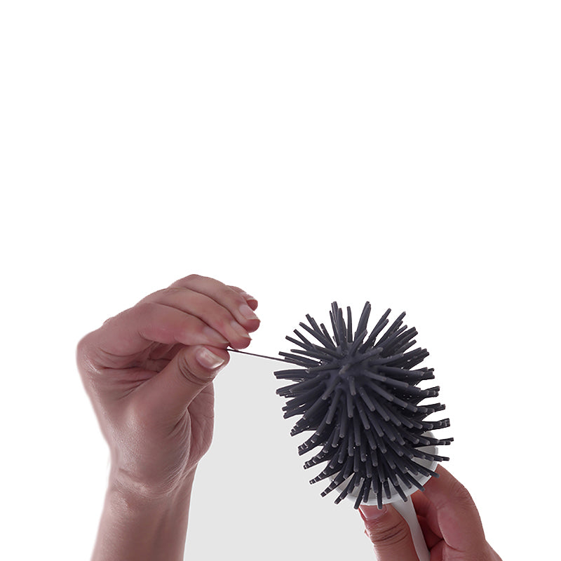 "Silicone toilet brush with non-scratch bristles, white wall-mounted design, keeps bathrooms pristine and surfaces undamaged.