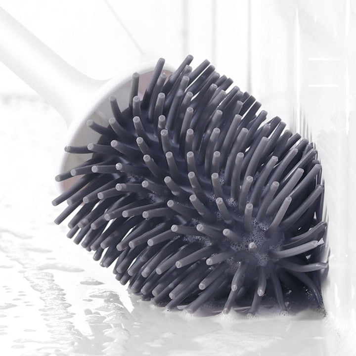"Silicone toilet brush with non-scratch bristles, white wall-mounted design, keeps bathrooms pristine and surfaces undamaged.