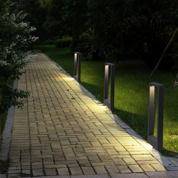 "Sleek waterproof outdoor LED garden light illuminating garden paths, robust aluminum build with modern minimalist design."