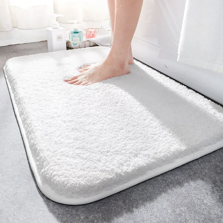 "Soft plush microfiber bathroom rug, beige, providing ultimate comfort with non-slip backing and excellent absorbency."