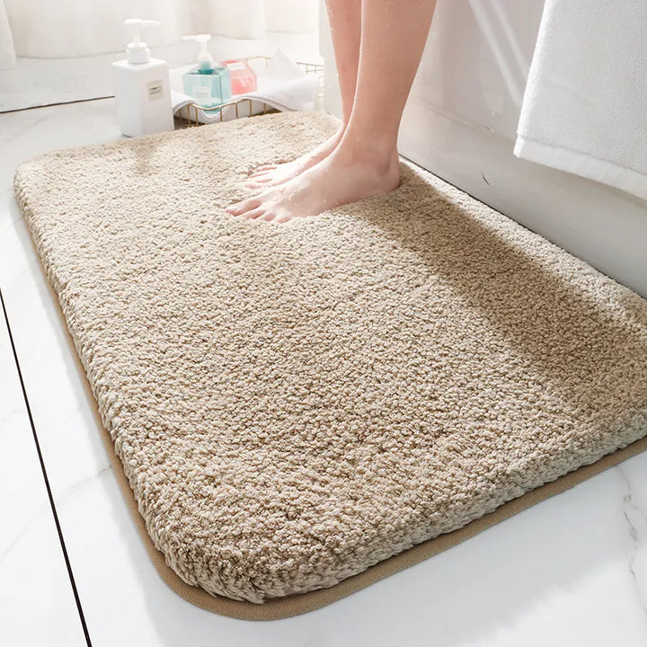 "Soft plush microfiber bathroom rug, beige, providing ultimate comfort with non-slip backing and excellent absorbency."