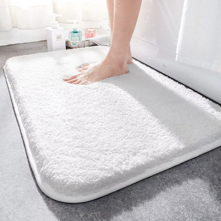 "Soft plush microfiber bathroom rug, beige, providing ultimate comfort with non-slip backing and excellent absorbency."