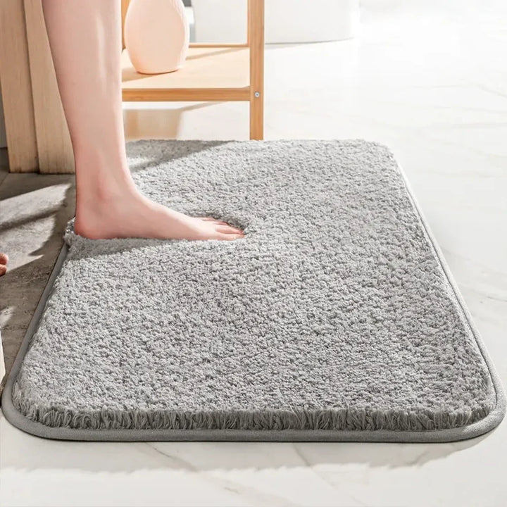 "Soft plush microfiber bathroom rug, beige, providing ultimate comfort with non-slip backing and excellent absorbency."