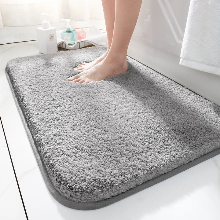 "Soft plush microfiber bathroom rug, beige, providing ultimate comfort with non-slip backing and excellent absorbency."