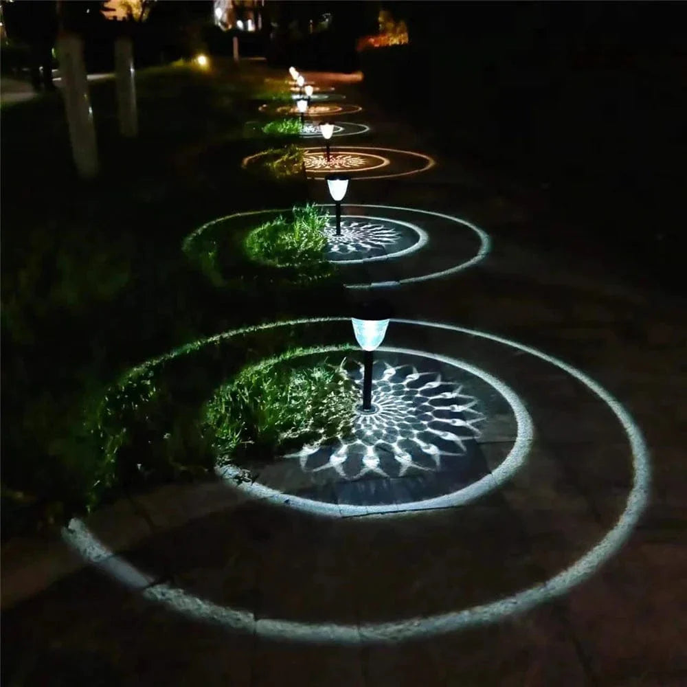 "Solar LED Mandala Garden Light casting intricate shadows on pathway, showcasing artistic outdoor illumination at night."
