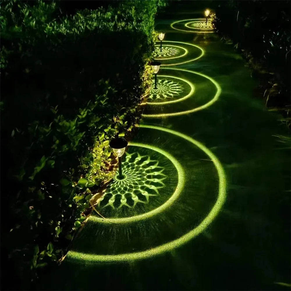 "Solar LED Mandala Garden Light casting intricate shadows on pathway, showcasing artistic outdoor illumination at night."