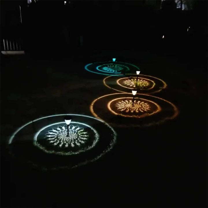"Solar LED Mandala Garden Light casting intricate shadows on pathway, showcasing artistic outdoor illumination at night."