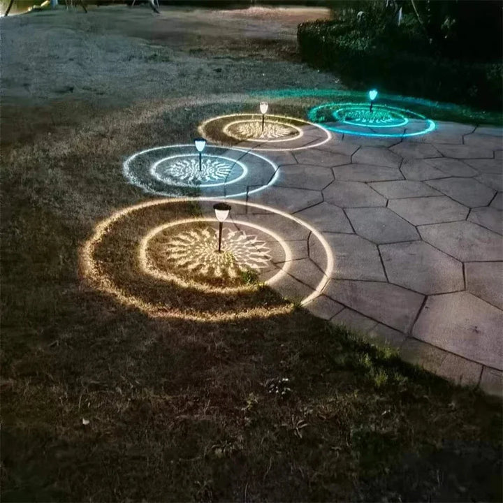 "Solar LED Mandala Garden Light casting intricate shadows on pathway, showcasing artistic outdoor illumination at night."