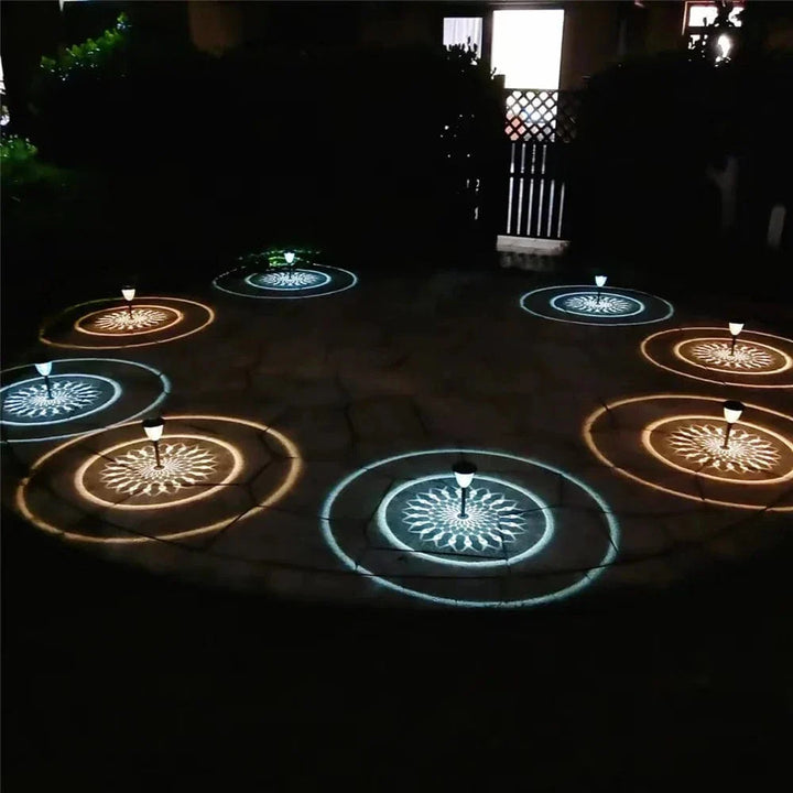 "Solar LED Mandala Garden Light casting intricate shadows on pathway, showcasing artistic outdoor illumination at night."