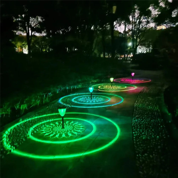"Solar LED Mandala Garden Light casting intricate shadows on pathway, showcasing artistic outdoor illumination at night."