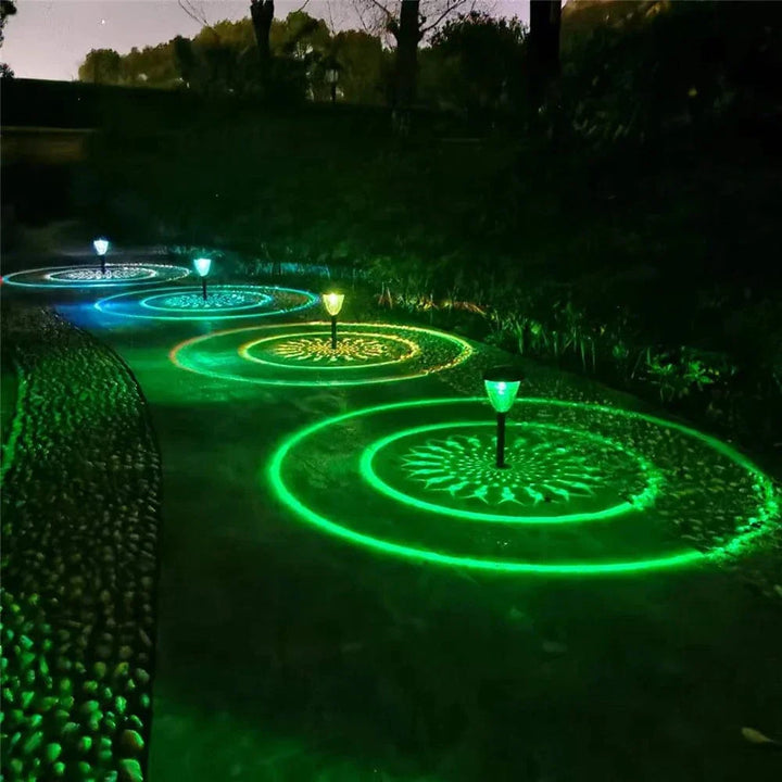 "Solar LED Mandala Garden Light casting intricate shadows on pathway, showcasing artistic outdoor illumination at night."