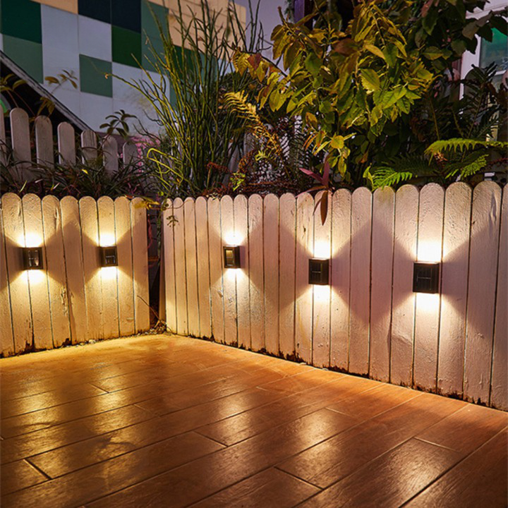 "Solar LED wall light for gardens, emitting bright white glow, mounted on dark background, ideal for pathways and patios."