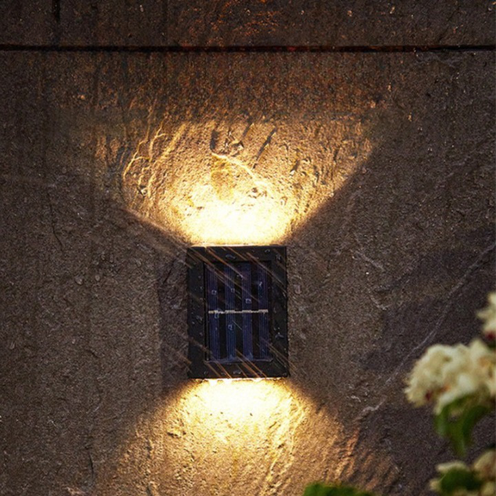 "Solar LED wall light for gardens, emitting bright white glow, mounted on dark background, ideal for pathways and patios."