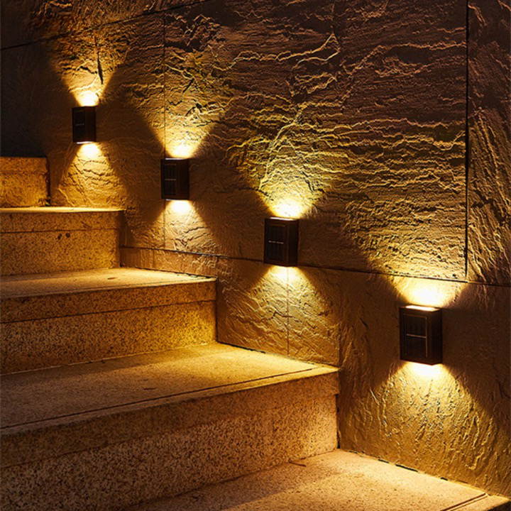 "Solar LED wall light for gardens, emitting bright white glow, mounted on dark background, ideal for pathways and patios."
