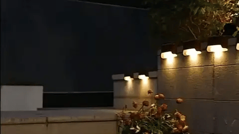 "Solar LED wall light for gardens, emitting bright white glow, mounted on dark background, ideal for pathways and patios."