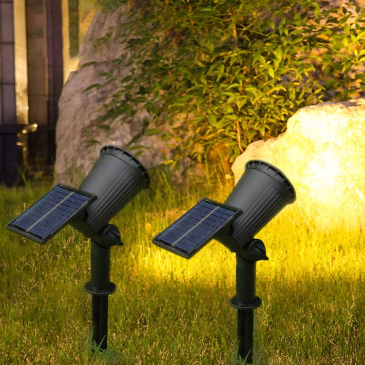 Solar-powered LED garden spotlight with sleek black design, adjustable head, and vibrant RGB lighting for outdoor use.