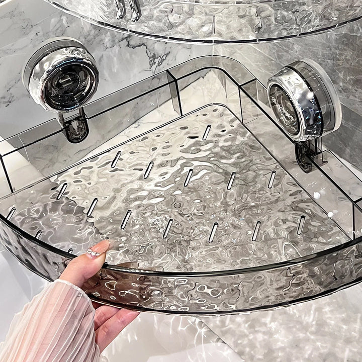 "Transparent no-drill bathroom caddy with strong suction cups, mounted on wall, for organizing toiletries and kitchen tools."