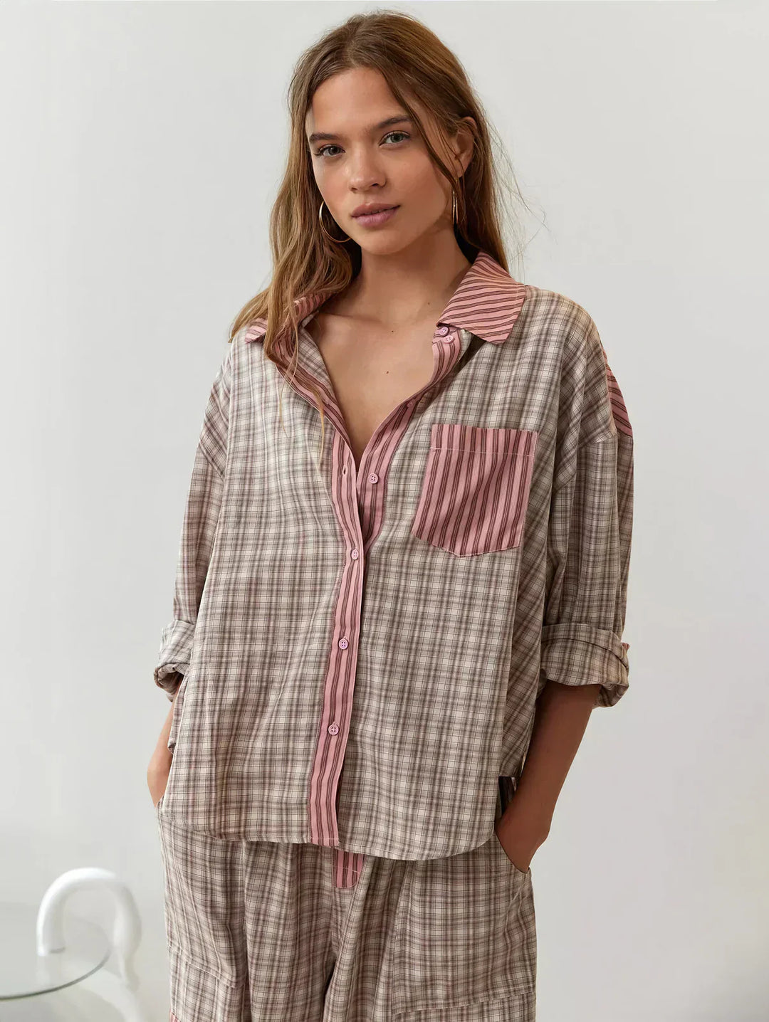 "Women's pink pajama set with elegant patterns, cozy relaxed fit, top and bottom included for stylish loungewear comfort."