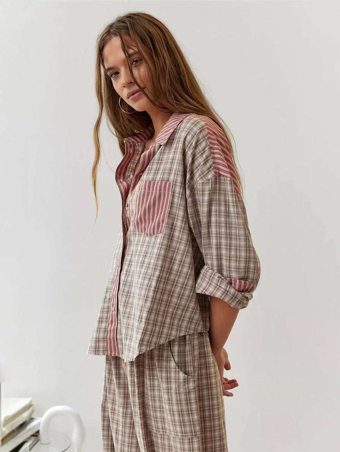 "Women's pink pajama set with elegant patterns, cozy relaxed fit, top and bottom included for stylish loungewear comfort."