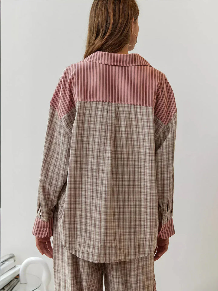 "Women's pink pajama set with elegant patterns, cozy relaxed fit, top and bottom included for stylish loungewear comfort."
