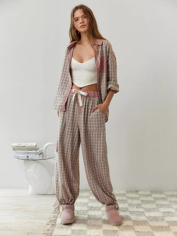 "Women's pink pajama set with elegant patterns, cozy relaxed fit, top and bottom included for stylish loungewear comfort."