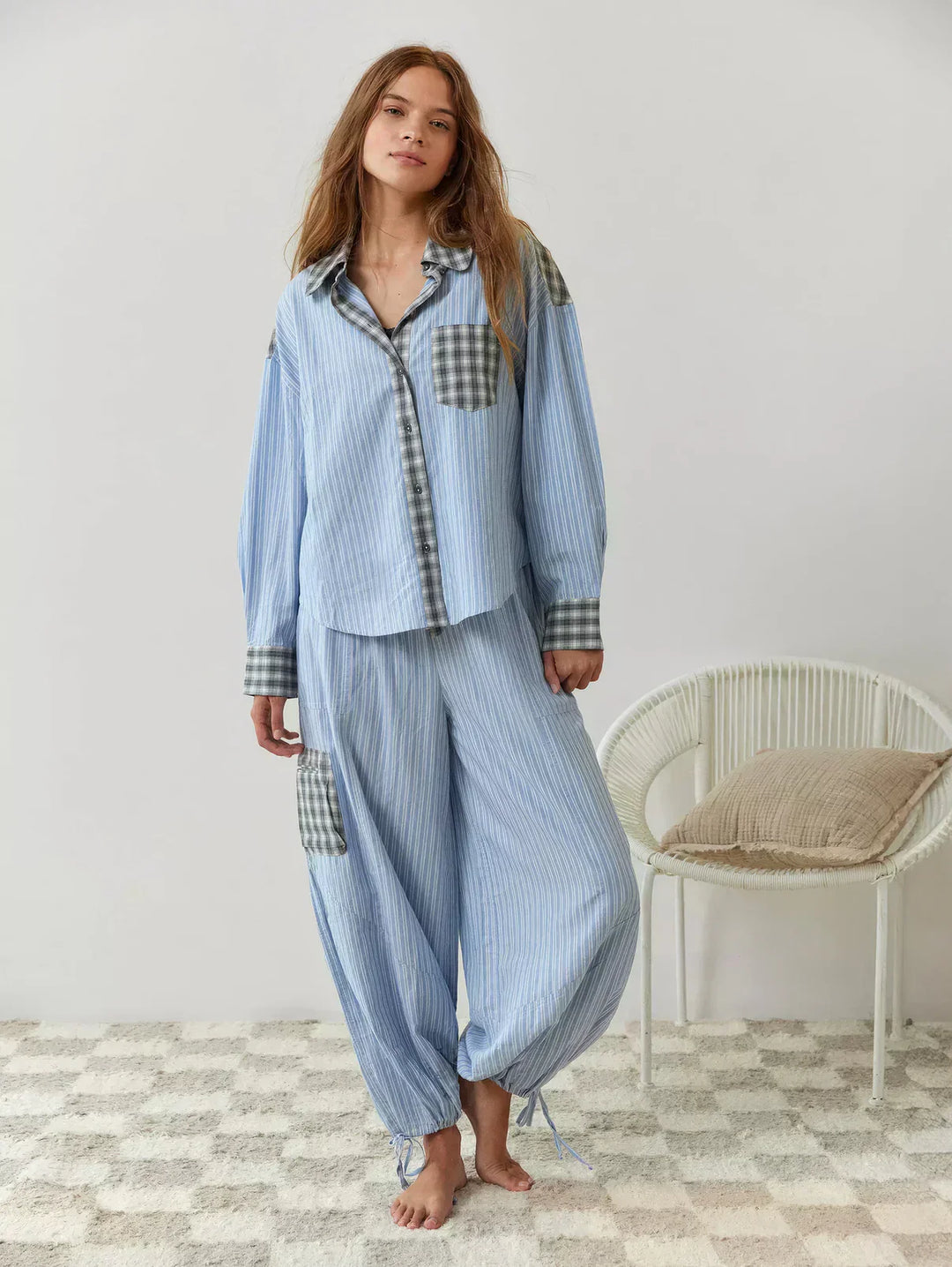 "Women's pink pajama set with elegant patterns, cozy relaxed fit, top and bottom included for stylish loungewear comfort."